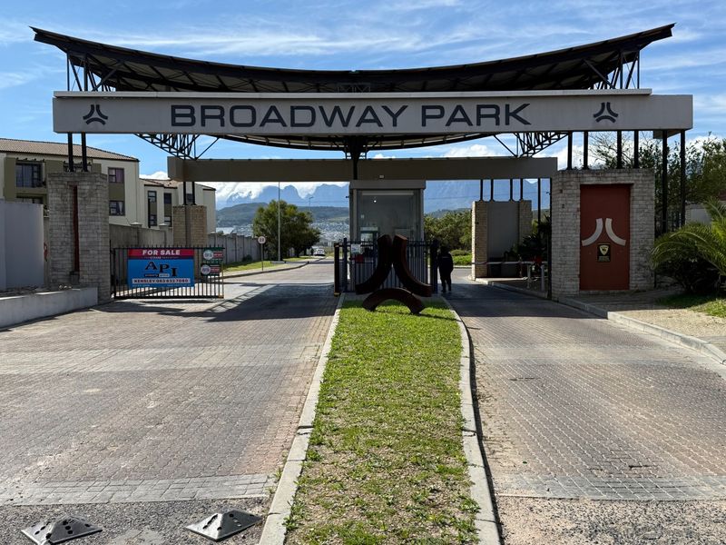 Main entrance gate and security checkpoint for Broadway Park commercial property, featuring paved access roads and professional signage.