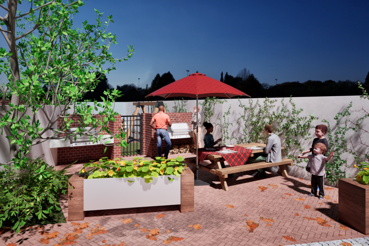 A well-maintained rear patio area featuring a brick built-in braai, paved flooring, and integrated planters, ideal for outdoor entertaining.