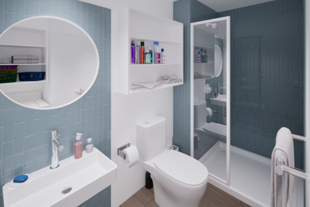 Modern bathroom featuring blue subway-style wall tiles, a wall-mounted basin, a walk-in shower enclosure, and integrated shelving.