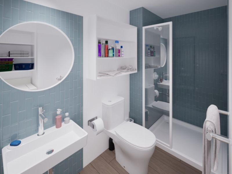 Modern bathroom featuring blue subway-style wall tiles, a wall-mounted basin, a walk-in shower enclosure, and integrated shelving.