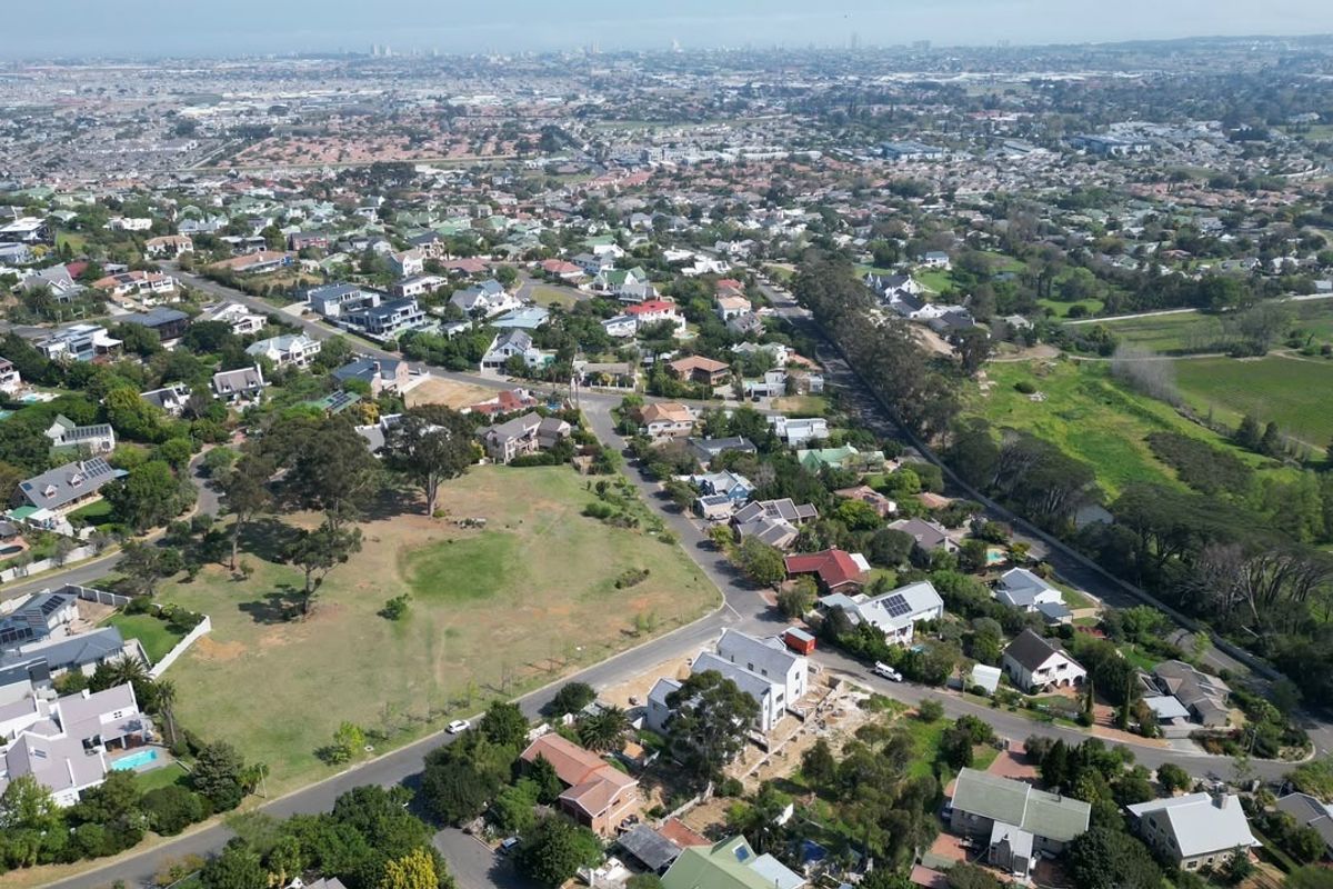 An aerial view of a residential neighborhood showcasing the surrounding landscape, street layout, and proximity to local amenities.