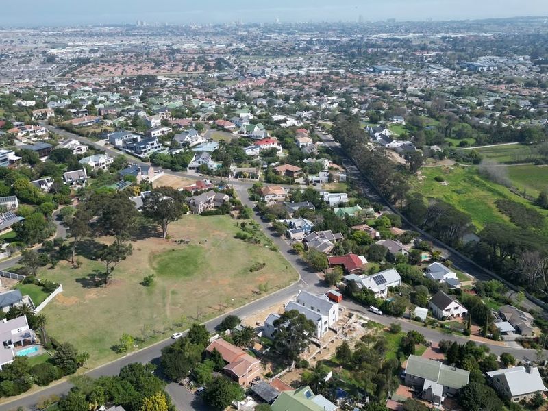 An aerial view of a residential neighborhood showcasing the surrounding landscape, street layout, and proximity to local amenities.