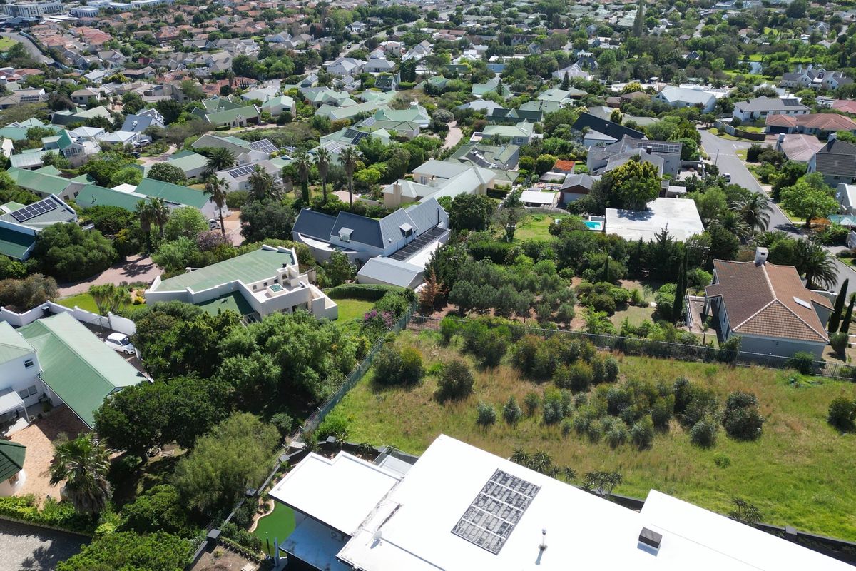 Aerial view of a residential property and surrounding neighborhood, showcasing the plot layout and established suburban landscape.