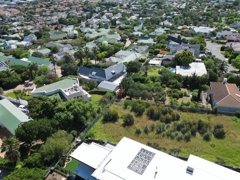 Aerial view of a residential property and surrounding neighborhood, showcasing the plot layout and established suburban landscape.