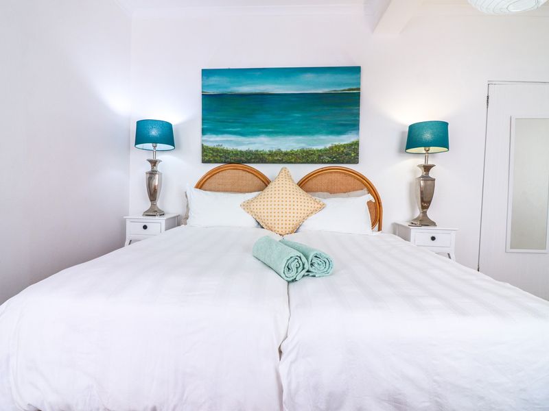 A well-maintained bedroom featuring neutral walls and a standard internal door, providing a clean and comfortable sleeping space.