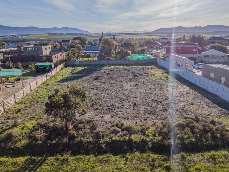 An elevated aerial view of a vacant residential plot, showing clear boundaries and surrounding neighborhood context.