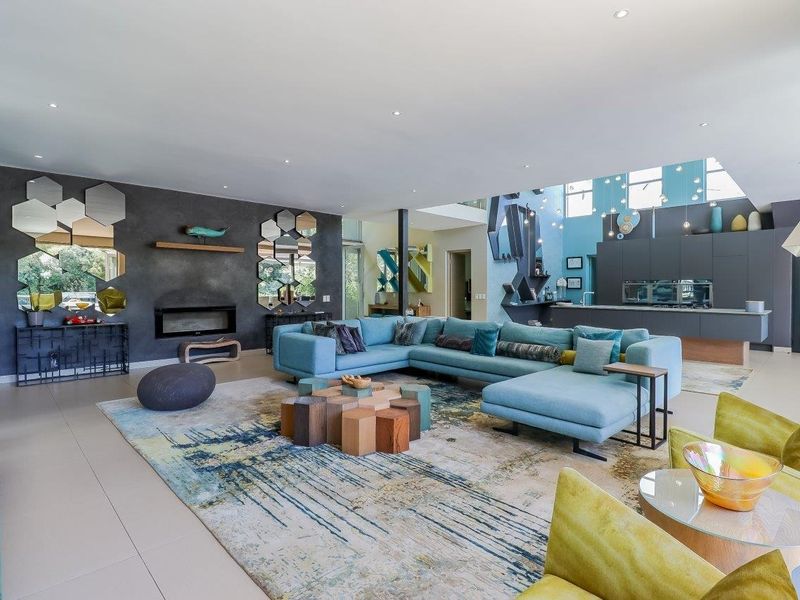 Spacious open-plan living area featuring a modern kitchen with island, recessed fireplace, and contemporary finishes throughout.