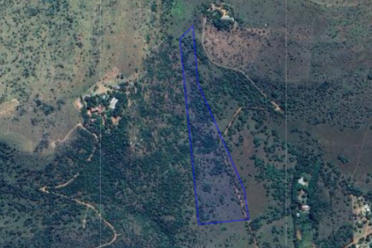 An aerial view of the small holding property, highlighting the land boundaries and surrounding natural landscape.