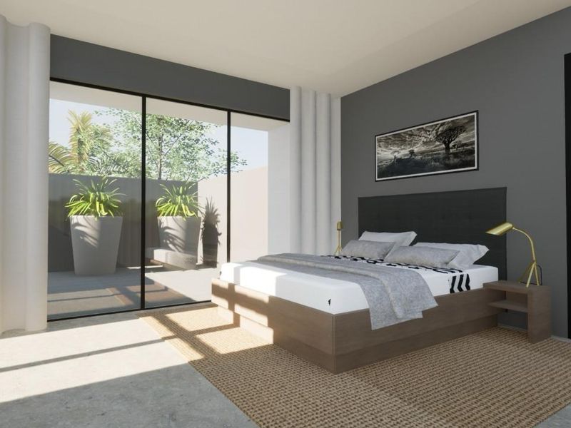 Modern bedroom featuring polished concrete floors and large sliding glass doors providing direct access to a private outdoor patio area.