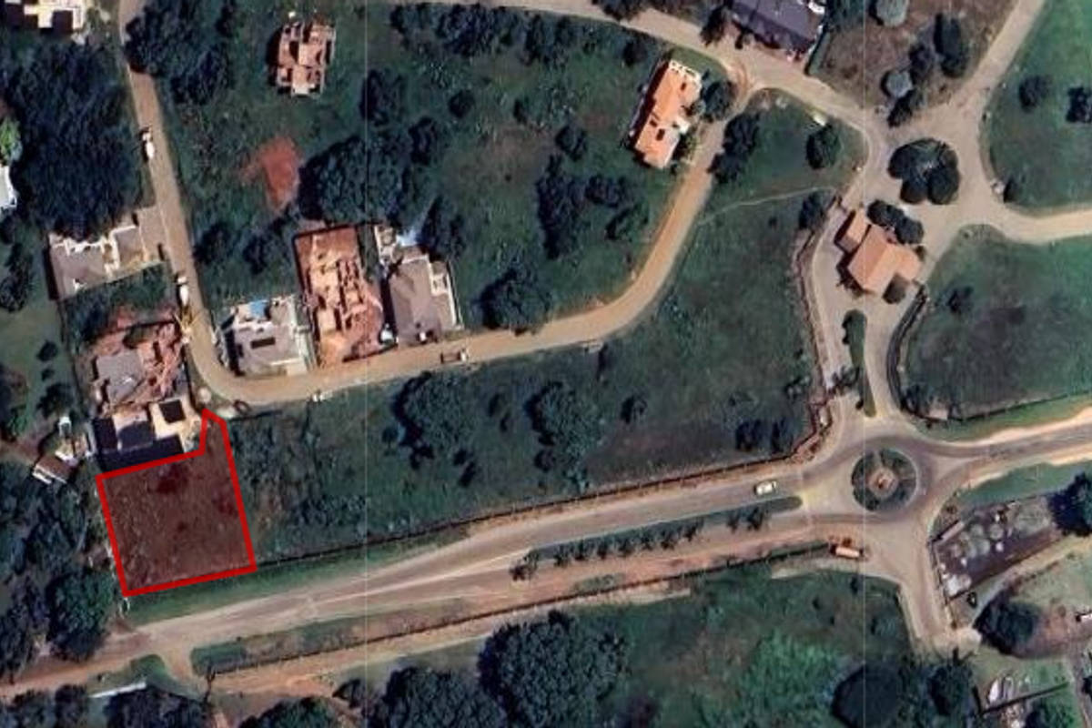Aerial view of a vacant residential land plot situated within a developed estate, highlighting its location and surrounding infrastructure.