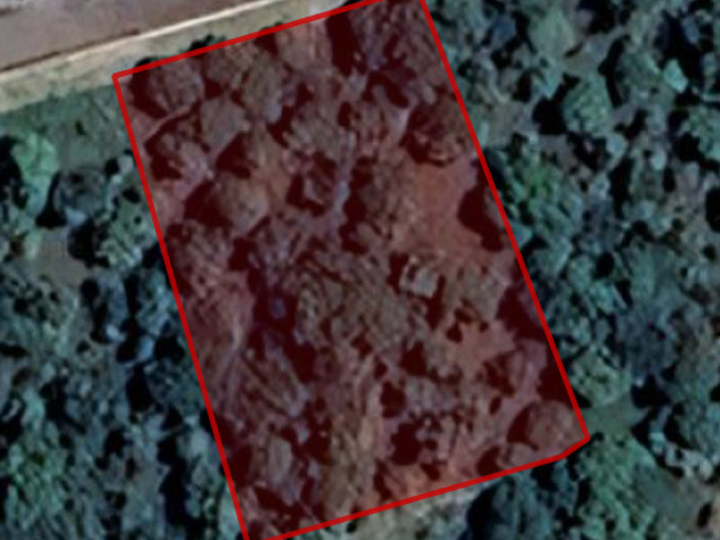 An aerial view showing the boundary of a vacant residential land plot.