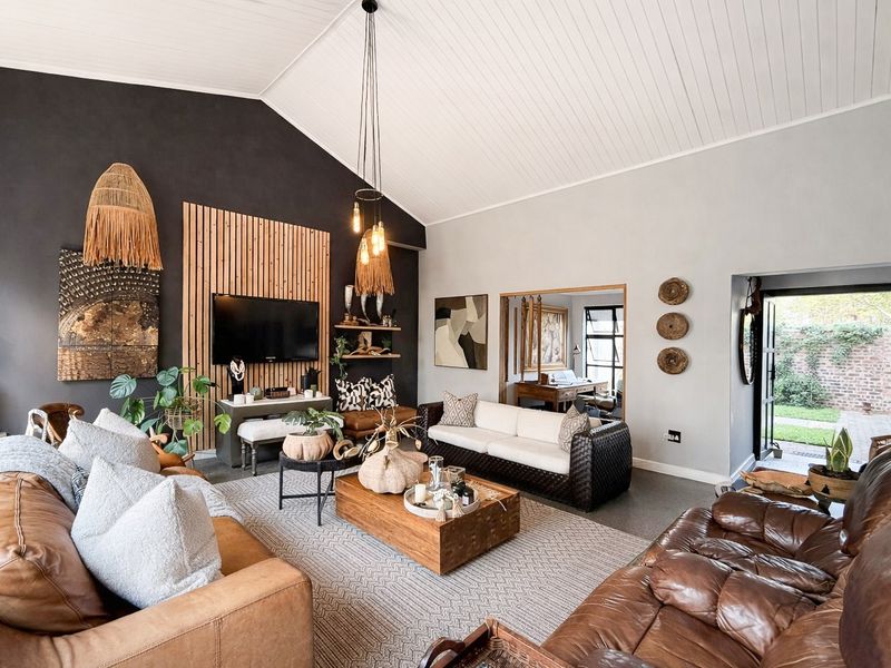 Spacious living room featuring a vaulted tongue and groove ceiling, timber slat feature wall, and direct access to the rear garden.