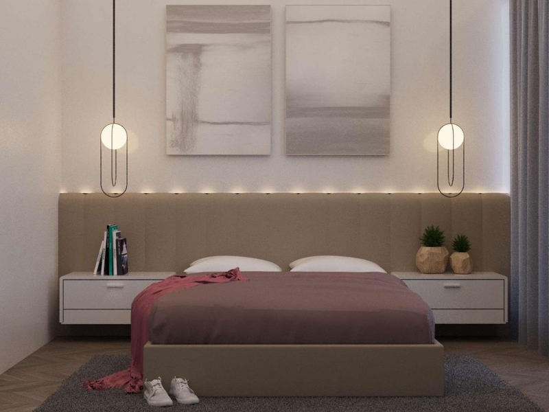 Modern bedroom featuring a custom upholstered headboard, integrated LED accent lighting, elegant pendant fixtures, and high-quality herringbone timber flooring.