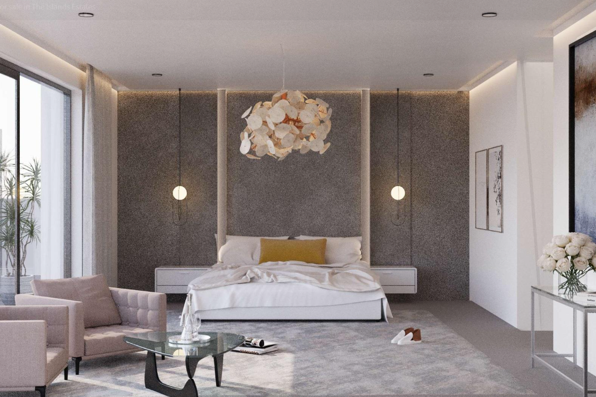 A modern, well-appointed bedroom featuring a textured feature wall, recessed lighting, and large sliding glass doors providing access to an outdoor area.