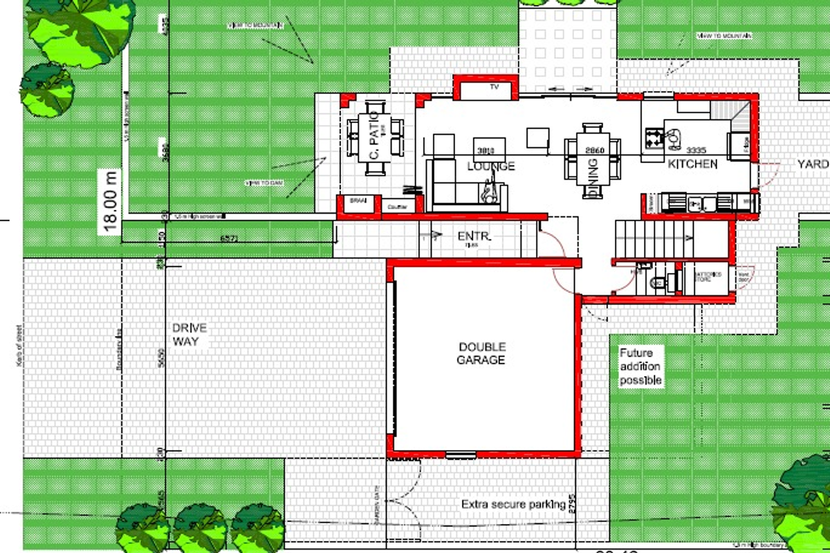 A detailed architectural floor plan showing the layout of a house including a double garage, open-plan living areas, kitchen, and outdoor patio space.