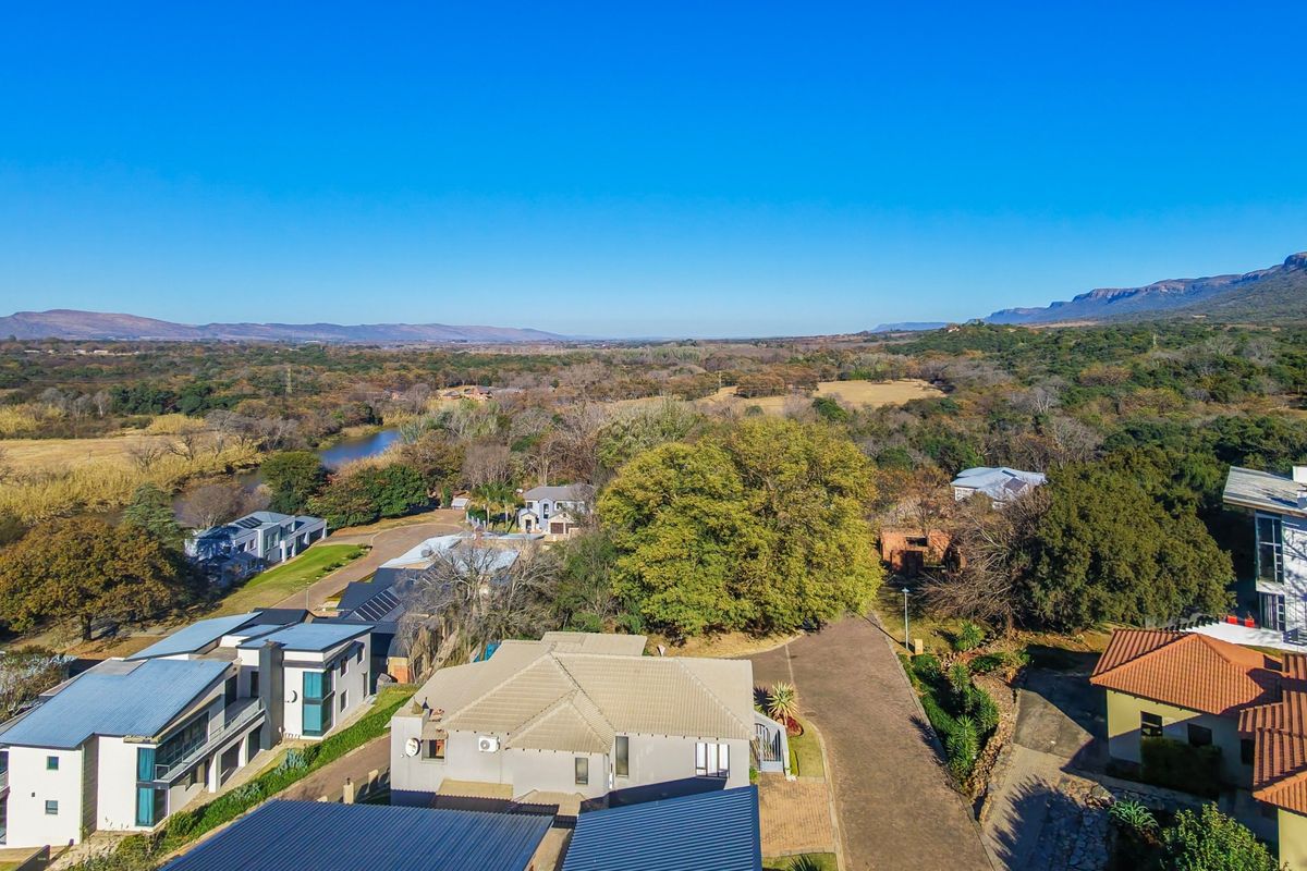 An aerial view of the residential estate, showcasing the surrounding landscape, natural vegetation, and the property's position within the neighbourhood.