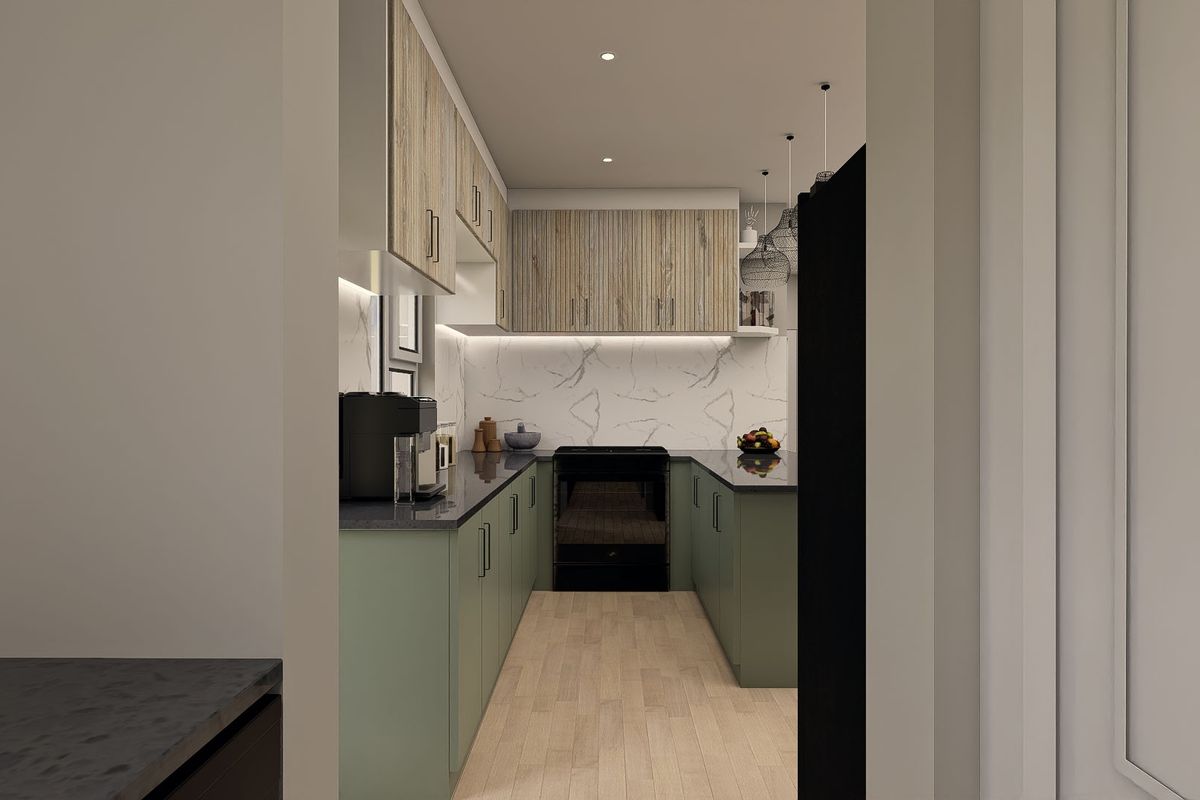 A modern galley-style kitchen featuring sage green lower cabinetry, wood-grain upper cabinets, dark stone countertops, and a marble-look backsplash.