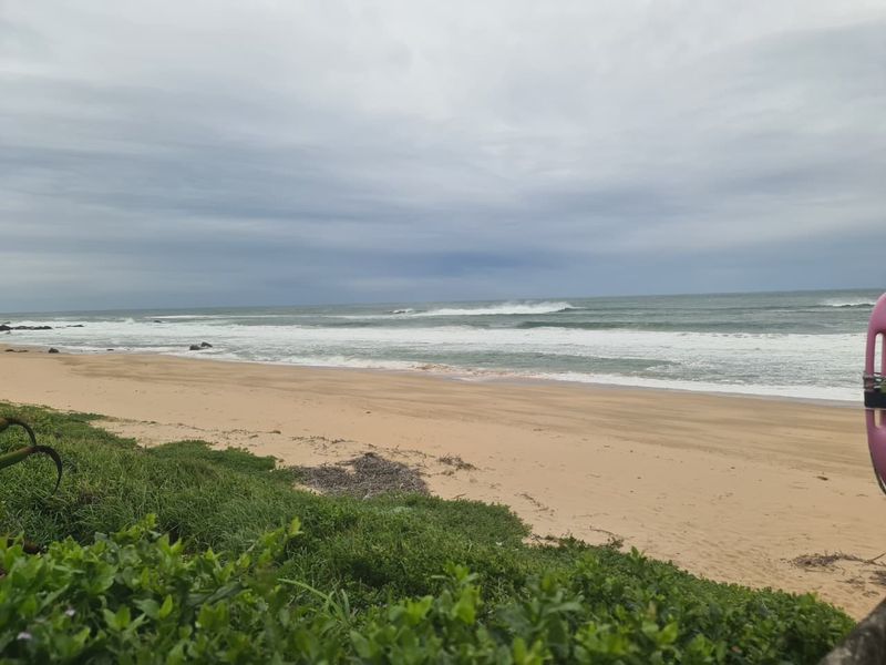 A scenic view of the ocean and sandy beach coastline.