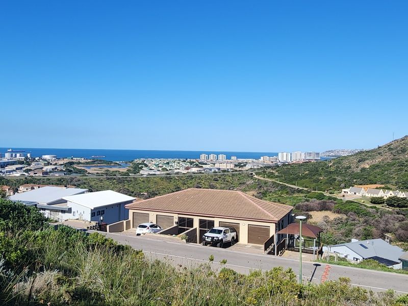 Elevated panoramic view overlooking the coastal landscape, surrounding residential properties, and the distant ocean horizon.