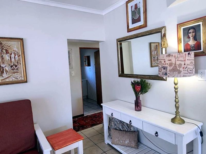 A bright entry area featuring neutral walls, tiled flooring, and coved ceiling details, providing a welcoming transition into the home's interior spaces.