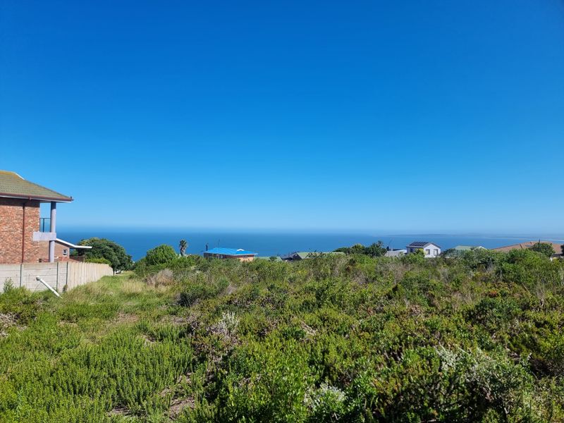 A scenic view overlooking the coastal landscape and ocean horizon from the vacant residential property.
