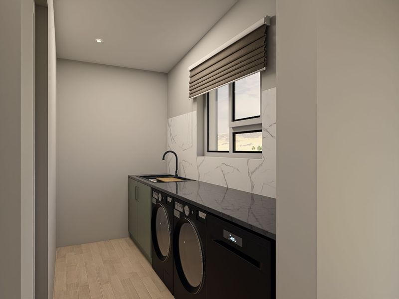 A modern, minimalist laundry room featuring sleek cabinetry, stone countertops, marble-look splashback, and integrated appliance spaces.