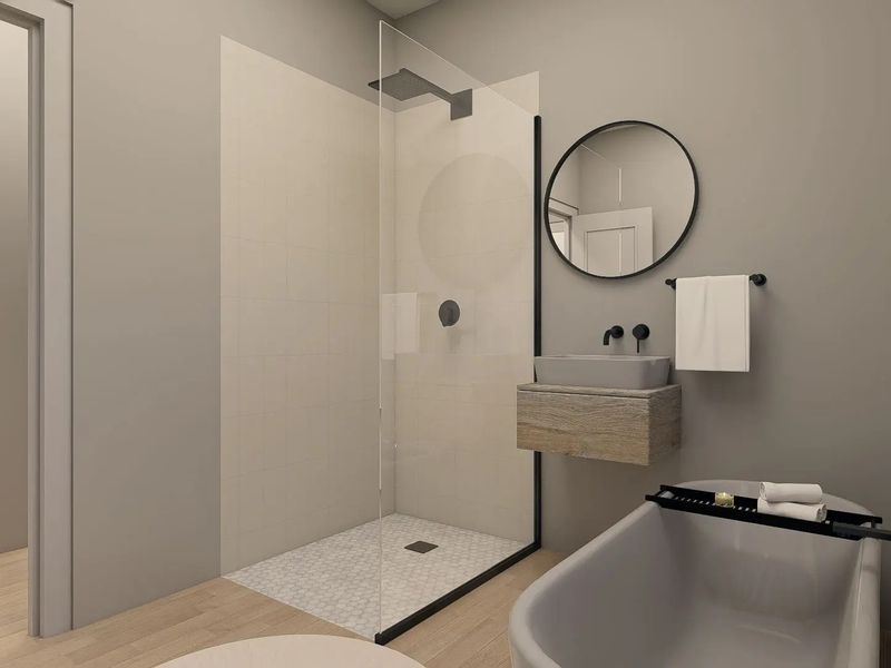 Modern bathroom featuring a walk-in shower with glass screen, wall-mounted vanity with vessel sink, and a sleek freestanding bathtub with matte black fixtures.