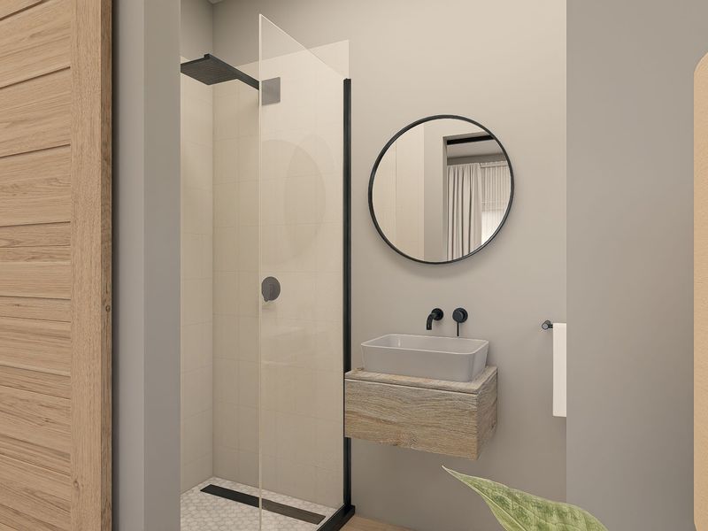Modern bathroom featuring a walk-in shower with black matte fixtures, a floating vanity with a vessel sink, and a stylish round mirror.