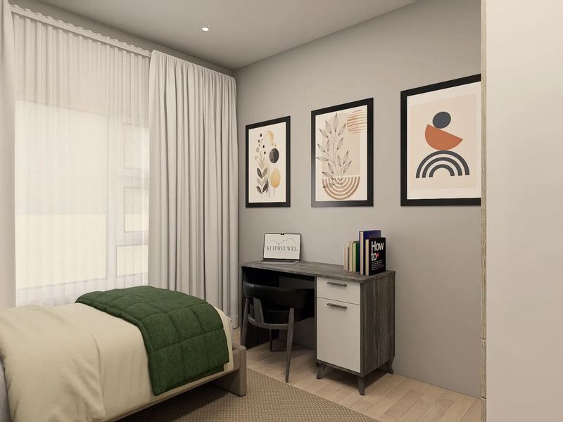 A modern, well-lit bedroom featuring neutral wall tones, laminate flooring, and recessed ceiling lighting, creating a clean and contemporary living space.