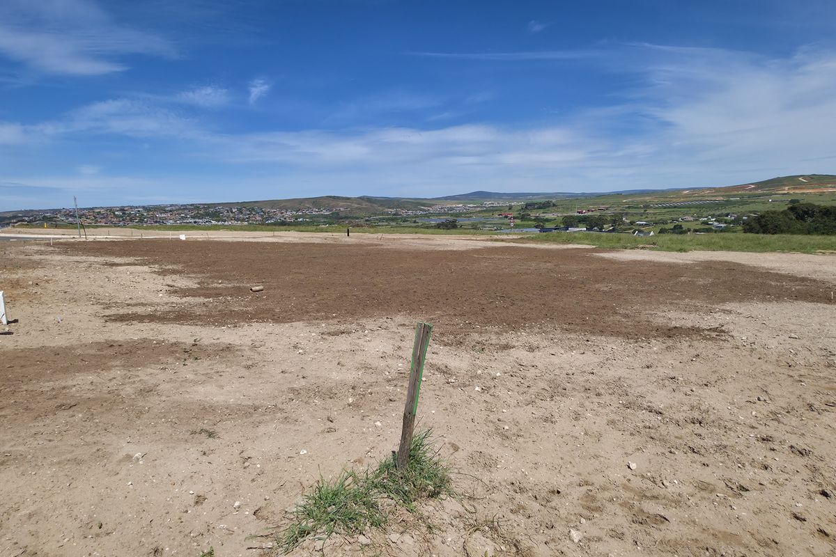 A vacant residential plot of land featuring clear road access and expansive landscape views, ready for development.