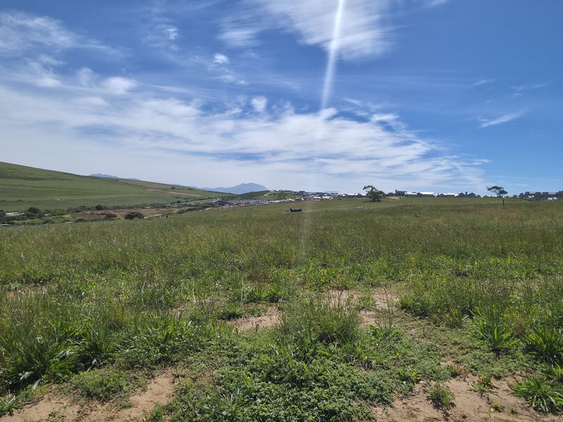 A wide-angle view of the vacant residential land, showcasing the natural landscape and surrounding area.