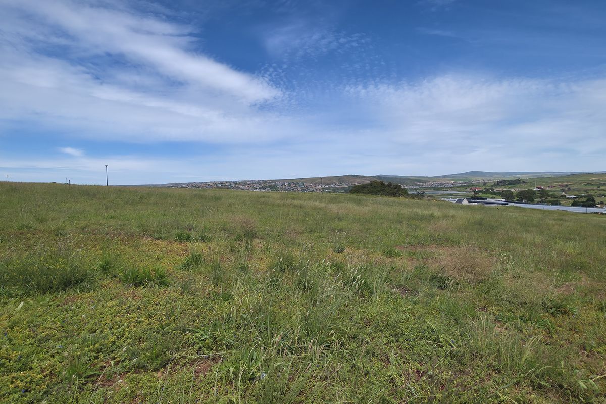 A wide-angle view of the vacant residential land, showcasing the natural landscape and surrounding area.