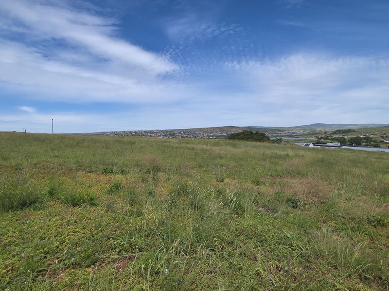 A wide-angle view of the vacant residential land, showcasing the natural landscape and surrounding area.