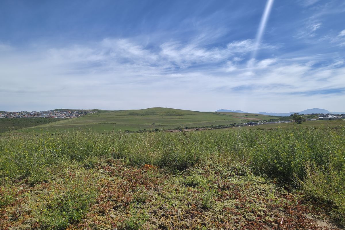 A panoramic view of the vacant residential land, showcasing the natural landscape and surrounding neighborhood terrain.