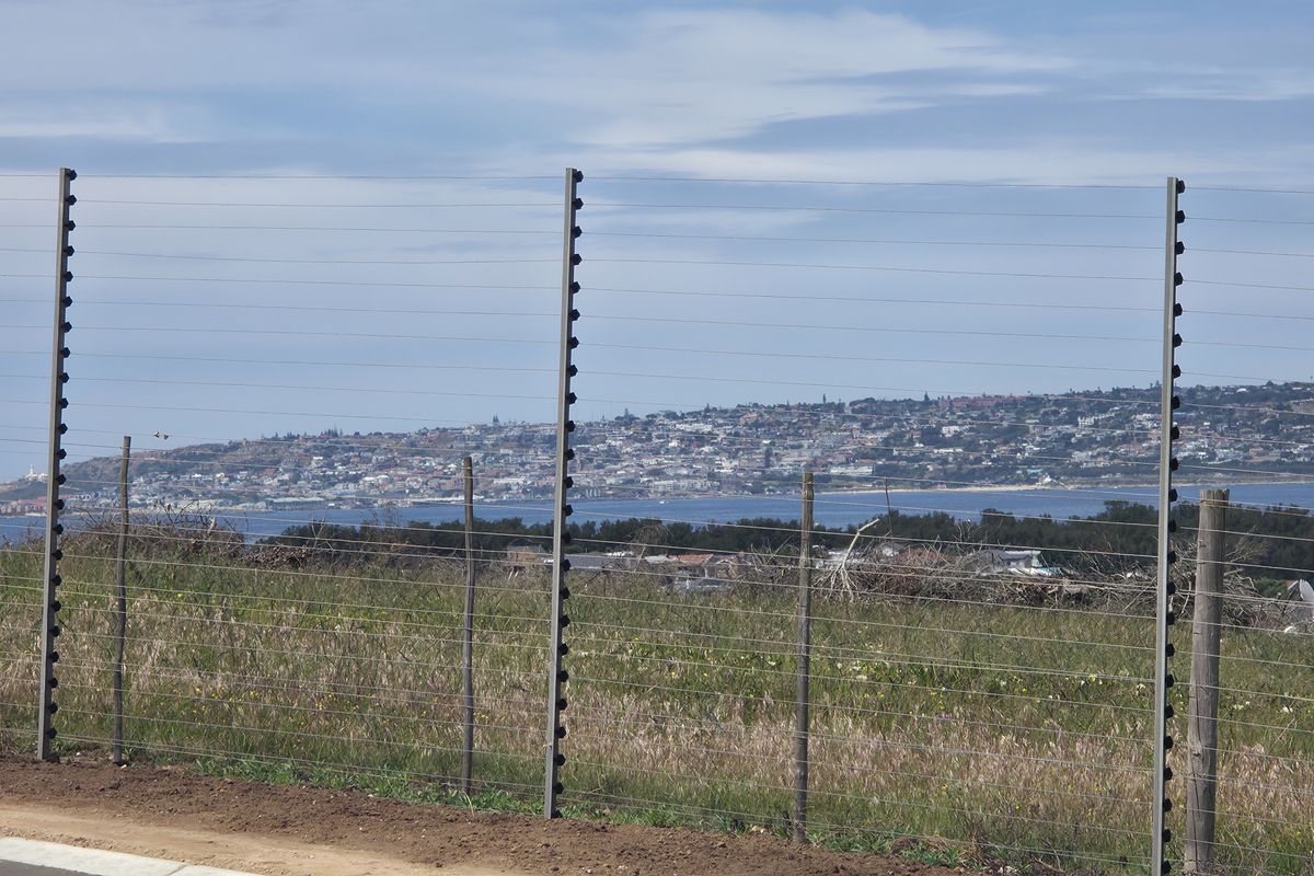 A scenic view overlooking the coastal landscape and town, captured from the edge of the vacant residential property.