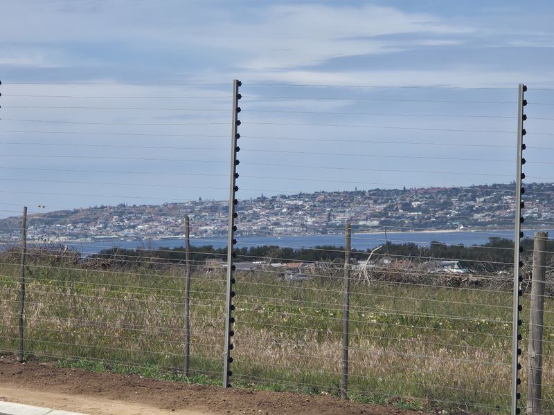 A scenic view overlooking the coastal landscape and town, captured from the edge of the vacant residential property.
