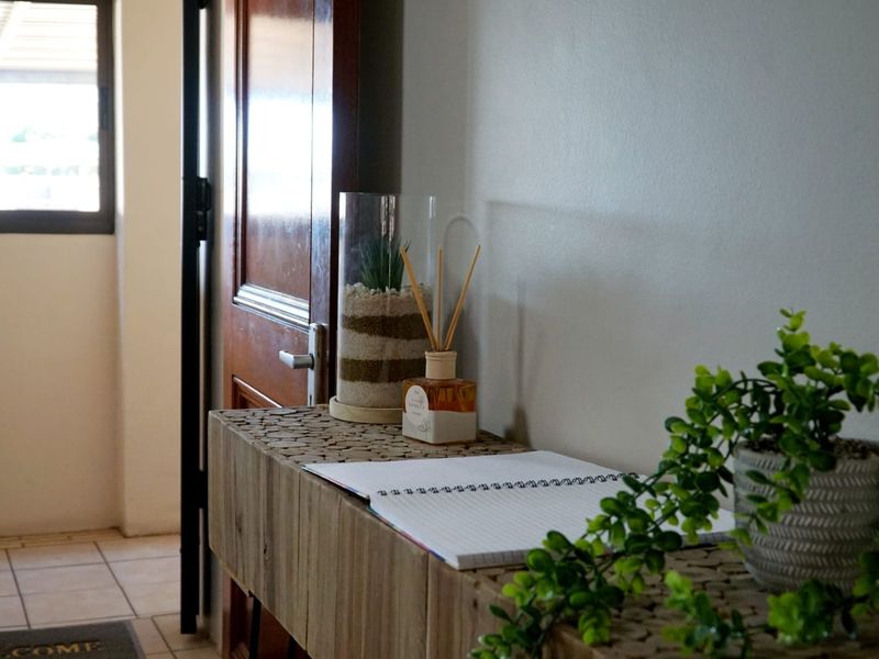 A view of the apartment entrance featuring a timber door and tiled flooring.