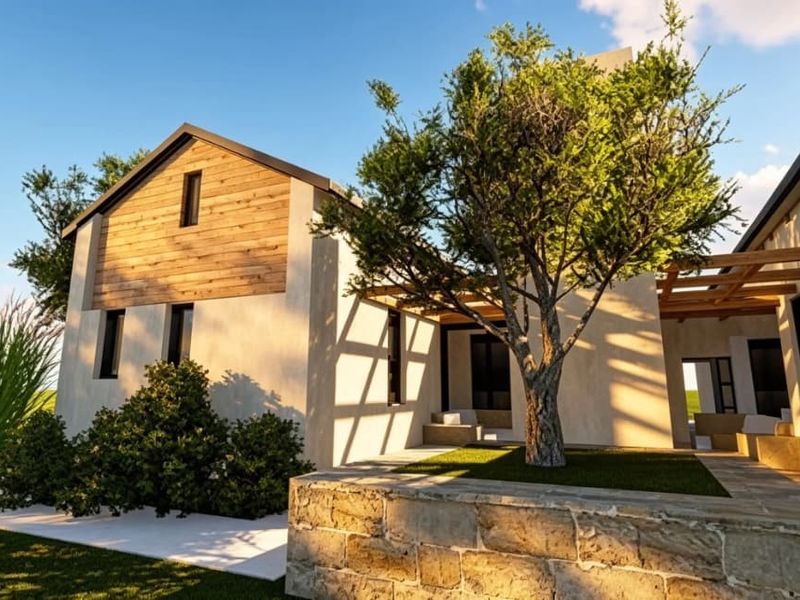 A modern architectural exterior view featuring timber cladding, a stone retaining wall, and a covered patio area set within a landscaped garden.