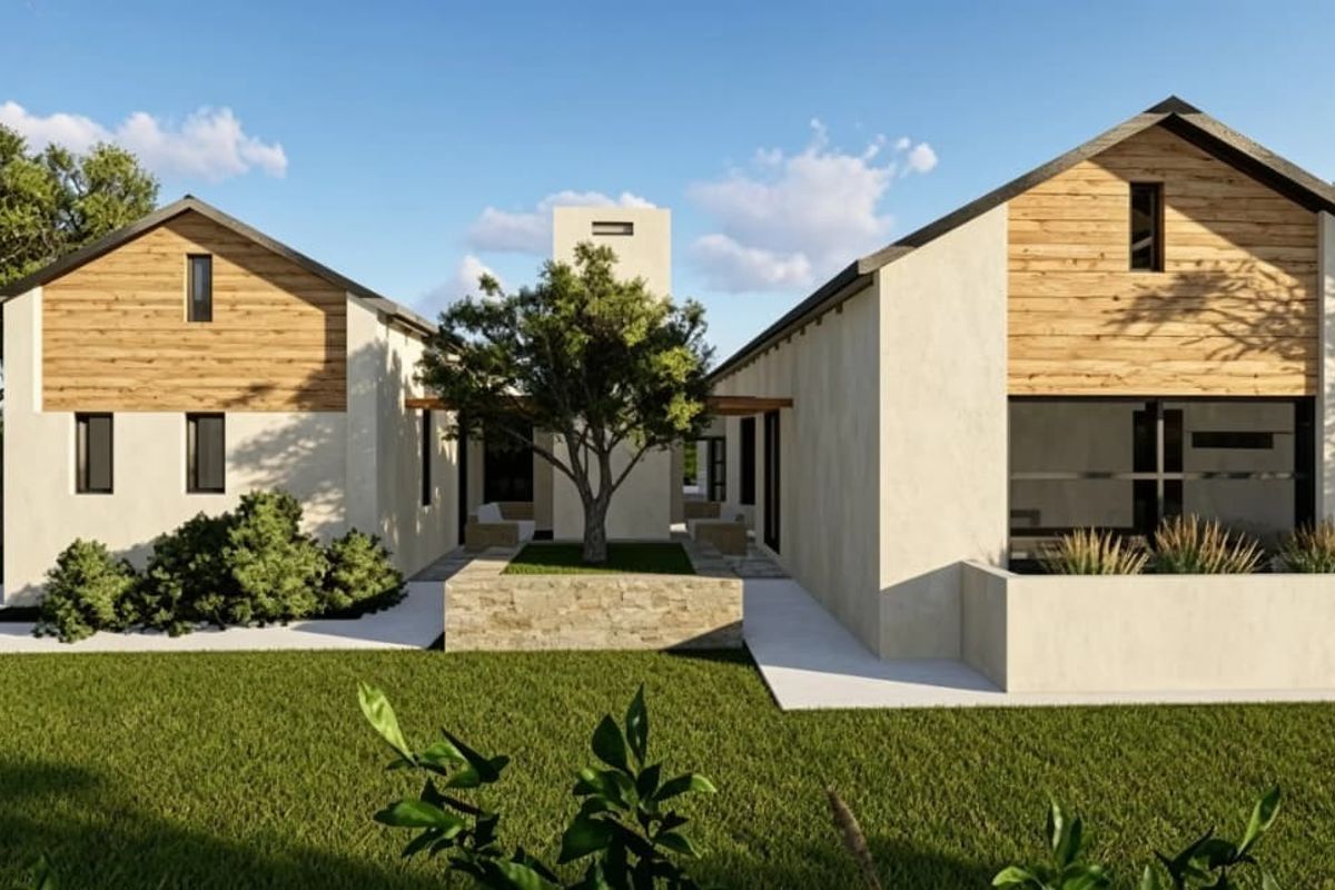 A modern architectural exterior view featuring dual pitched-roof structures with timber cladding, stone accents, and a central landscaped courtyard area.