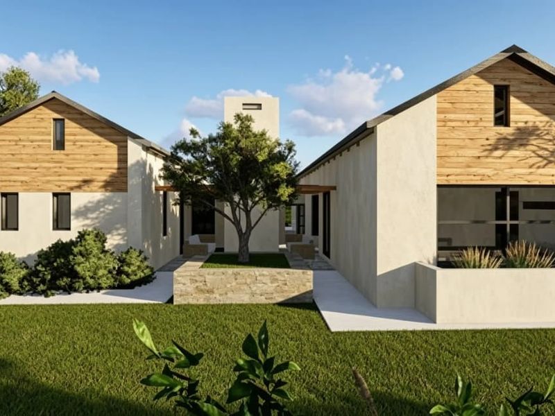 A modern architectural exterior view featuring dual pitched-roof structures with timber cladding, stone accents, and a central landscaped courtyard area.
