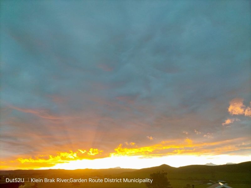 A scenic view of the sunset over the landscape in the Garden Route District Municipality.