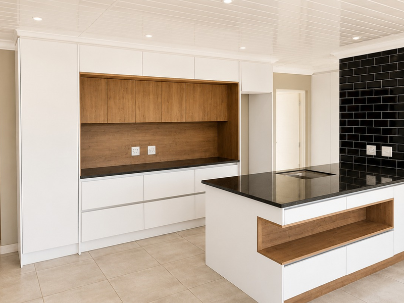 Modern kitchen featuring white and wood-tone cabinetry, a central island with stone countertops, black subway tile backsplash, and recessed ceiling lighting.