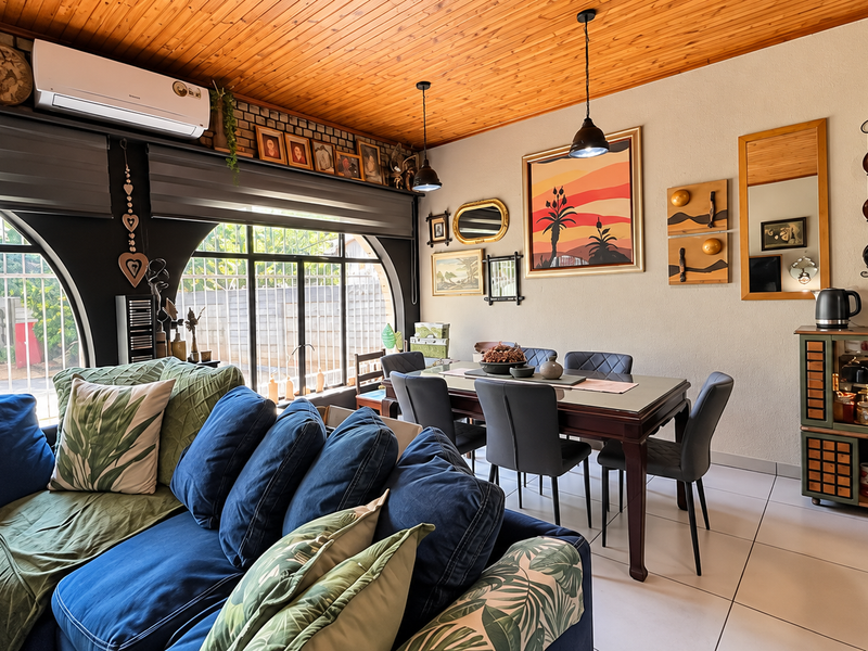 Open-plan living and dining area featuring a timber ceiling, arched windows, tiled flooring, and a split-system air conditioner.