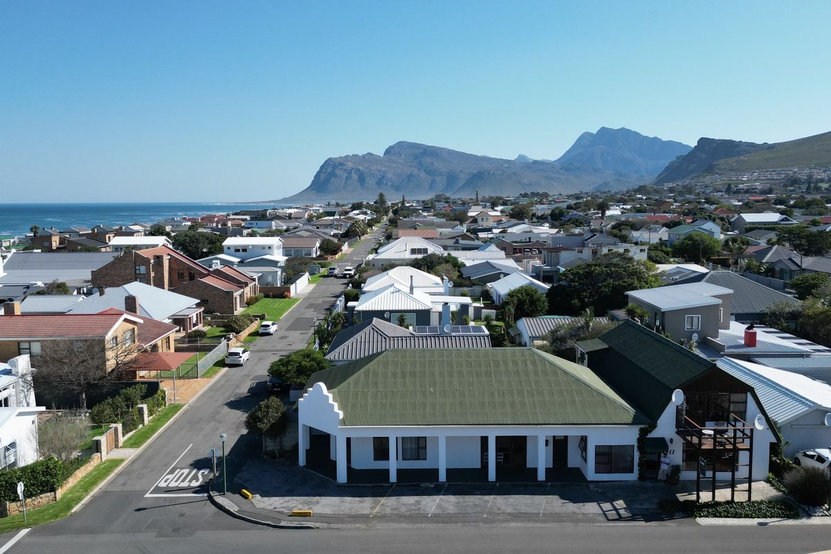 Aerial view of the property showing its location within the coastal neighbourhood, featuring a pitched roof structure and convenient street-level access.