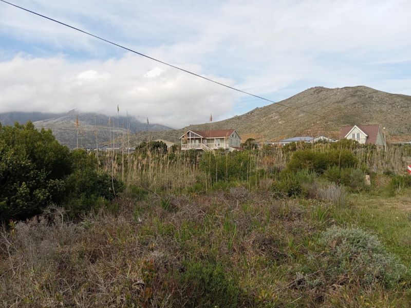 A scenic view of the surrounding landscape featuring natural vegetation and distant mountain ranges.