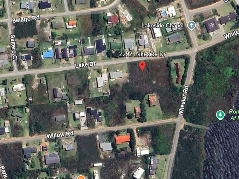 An aerial view showing the vacant residential plot located at 2292 Lakeside Drive, situated in a developed neighborhood near the lake.