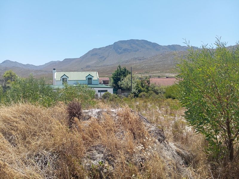 A scenic view of the surrounding landscape and mountains from the vacant residential land plot.