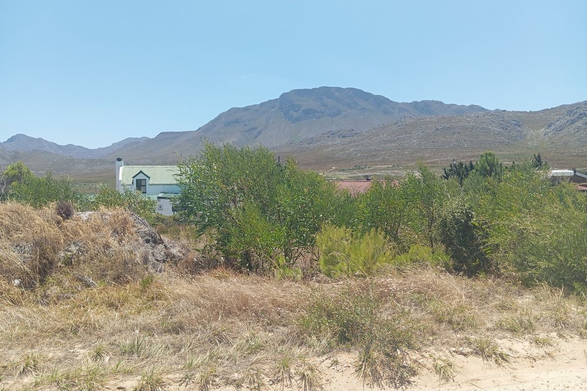 A scenic view of the surrounding landscape and mountains from the vacant residential property.