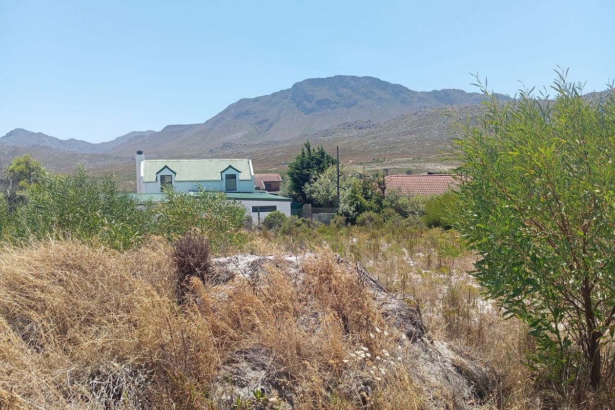 A scenic view of the surrounding landscape and mountains from the vacant residential land plot.
