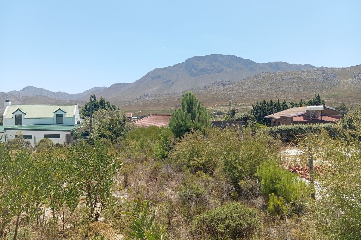 A scenic view of the surrounding residential area and mountain range from the vacant residential plot.